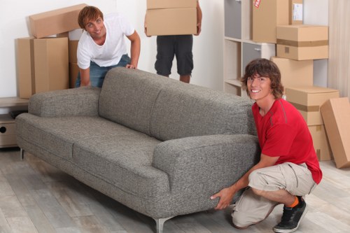 Carefully wrapped furniture being moved through a hallway